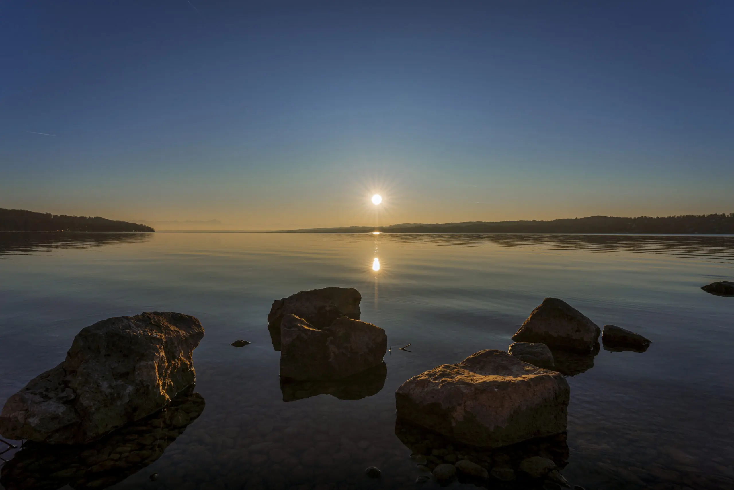 Wandbild (5792) Wintersonne am Ammersee by Judith Grote präsentiert: Wasser,Details und Strukturen,Natur,Landschaften,Winter,Berge,Seen,Wasserspiegelungen,Steine
